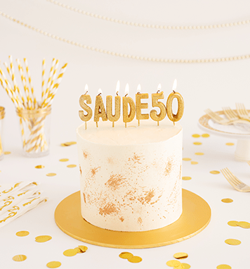 Bolo branco com velas douradas e canudos listrados
